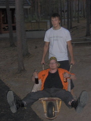 Chia driving the wheelbarrow, Haardo enjoying the ride.